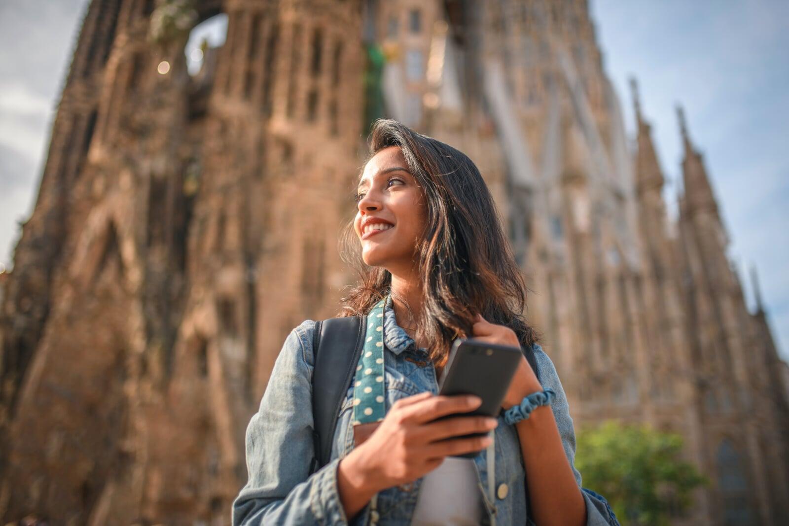 A female traveler enjoying visiting Sagrada Familia in sunny Barcelona